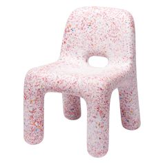 a pink plastic chair with sprinkles on the back and seat, in front of a white background