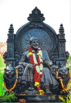 the statue is decorated with flowers and garlands