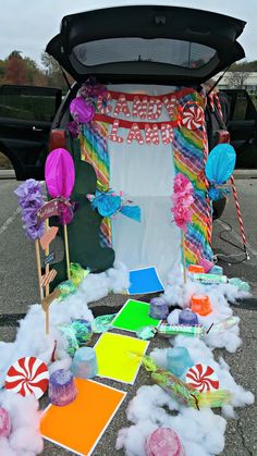 the trunk of a car is filled with candy and candies, including lollipops