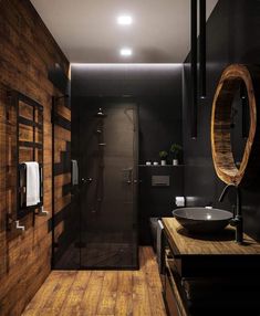 a bathroom with wooden floors and black walls