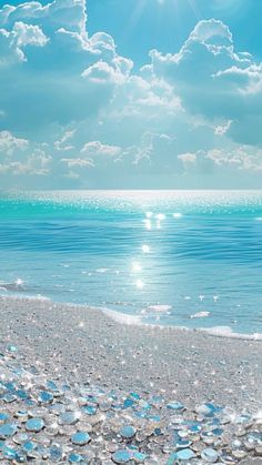 the sun shines brightly over an ocean beach with clear blue water and bubbles in the sand