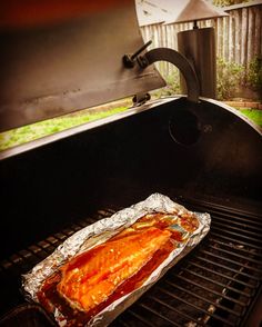 a fish is cooking on the grill outside