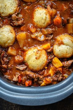 a crock pot filled with meat and potatoes