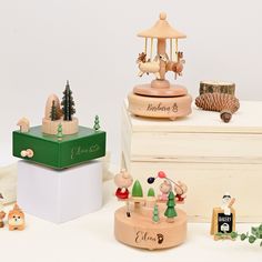 several wooden toys are sitting on top of a white box and one has a birdcage