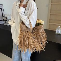 Elevate your summer style with the Andreia Long Tassel Straw Bag! Made from high-quality straw, this bag features a chic tassel design and spacious interior, perfect for carrying all your essentials. Whether you're headed to the beach or a brunch date, this bag will add a touch of bohemian luxury to any outfit. SIZE: W44cm x H38cm x D8cm / W17.3" x H15" x D3.2" Gender: WOMEN Item Type: Handbags & Shoulder Bags, Straw Bags Main Material: Straw Pattern Type: Knitting, Tassels Lining Material: POLY Jute Shoulder Bag With Braided Handles For Day Out, Trendy Fringe Shoulder Bag For Spring, Casual Brown Straw Bag With Tassels, Casual Fringe Beach Bag For Daily Use, Jute Bag With Braided Handles For Day Out, Jute Bags With Braided Handles For Day Out, Spring Fringe Shoulder Bag For Everyday, Trendy Beige Shoulder Bag With Fringe, Trendy Woven Hobo Bag For Beach