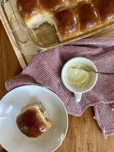 a loaf of bread sitting on top of a table next to a bowl of butter