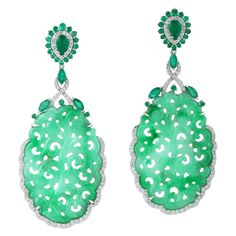 These stunning hand carved Jade earrings are thoughtfully and meticulously crafted in 18-karat gold. It is set in 32.66 carats Jade, 2.68 carats emerald and 1.12 carats of diamonds. FOLLOW MEGHNA JEWELS storefront to view the latest collection & exclusive pieces. Meghna Jewels is proudly rated as a Top Seller on 1stDibs with 5 star customer reviews. All items manufactured by us are handmade and can be customized or redesigned. Composition Size-63X27 MM Total Weight-20.446 Gold Weight(Gms)-13.154