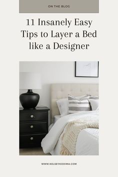 a white bed sitting next to a black dresser