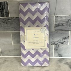 a purple and white chevron wrapping paper on a countertop in a kitchen with marble tiles