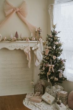 a decorated christmas tree in front of a fireplace