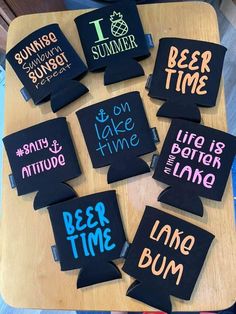 a wooden table topped with lots of black and pink coasters covered in different types of words