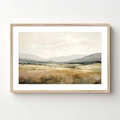 a painting hanging on the wall above a wooden frame that has a landscape in it