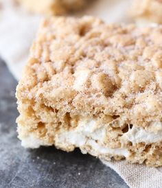 a close up of a piece of cake on a napkin with sugar crumbs