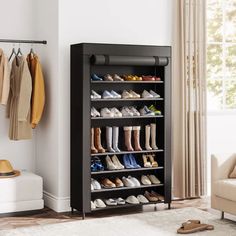 a black shoe rack with shoes on it in a living room next to a couch