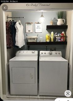 a washer and dryer in a small room with clothes hanging on the wall