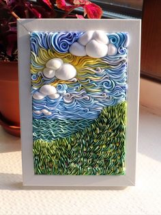 a card that has been made to look like clouds and grass