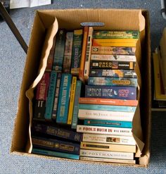 a cardboard box filled with lots of books