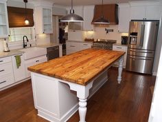 a kitchen with an island made out of wood