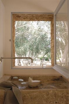 an open window in a bathroom next to a sink