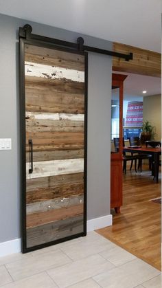 an open door with wood planks on the side and metal handles in front of it