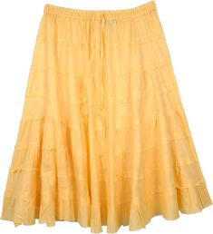 A beautiful cotton skirt with full tiers with an uneven hem in a pale yellow, this solid colored skirt is ideal for summer season.  The skirt is fully tiered and the wide hemline gives it a nice fall. #tlb #JuniorPetite #TieredSkirt #vacationclothing #beachwrap #Solid #shortskirt #tieredskirt #yellowcottonskirt Solid Color Tiered Skirt For Summer, Solid Color Tiered Gathered Skirt, Tiered Gathered Skirt In Solid Color, Yellow Ruffled Long Skirt, Yellow Tiered Ruffled Skirt, Tiered Cotton Skirt With Layered Hem, Tiered Summer Skirt, Yellow Tiered Gathered Skirt, Yellow Gathered Tiered Skirt