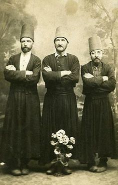 three men standing next to each other with their arms crossed and looking at the camera