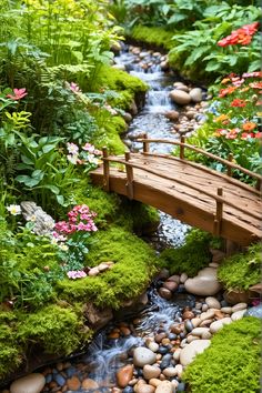 a small wooden bridge over a stream in a garden