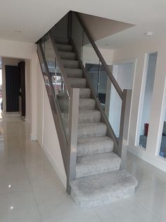 a staircase with glass balustrades in a house