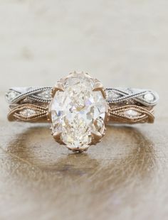 an oval shaped diamond ring with filigree band