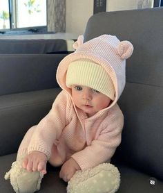 a baby is wearing a pink bear outfit