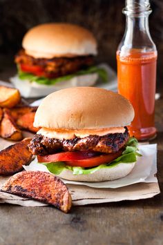 two burgers and some fries on a table