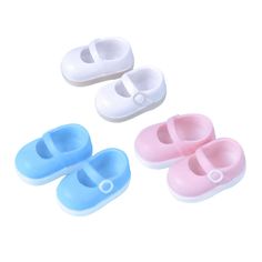 three pairs of baby shoes sitting next to each other