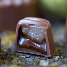 two pieces of chocolate sitting next to each other on top of a counter covered in licora