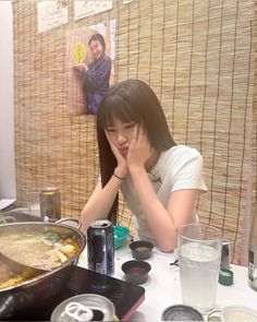 a woman sitting at a table with food in front of her