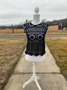 "Black Lacy Crochet Tank Top.  Great with a camisole underneath or as a bathing suit coverup.  Looks great with jean, shorts, or a skirt.   Bust 34\", length 19 in.  Approximate size M  Custom order - message me with color Custom Orders usually take about 2-3 weeks to create (not including shipping time). However, depending on the number of orders I have, it could take more or less time to make the item and ship it to you. If you need it by a certain day, feel free to message me and I can let you know if that will be possible!Dress form used is a size medium." Beachwear Tops With Crochet Trim For Beach Cover-up, Bohemian Lace Crop Top For Beach, Beachwear Tops With Crochet Trim For Beach Season, Beachwear Tops With Crochet Trim For Festivals, Sleeveless Crochet Lace Top For Beach Season, Fitted Crochet Top For Summer Beach Cover-up, Fitted Crochet Top For Beach Cover-up, Crochet Trim Tops For Beach Season, Sleeveless Lace Crop Top For Beach