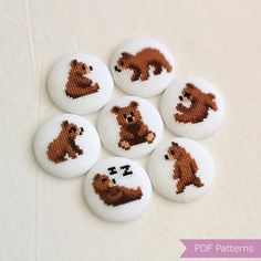 six brown bears are depicted on white buttons