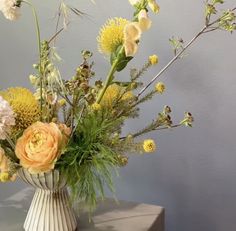 a vase filled with lots of different types of flowers