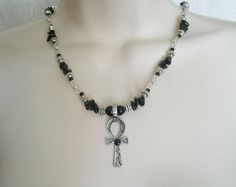 "Ankh Of Life Necklace This beautiful necklace has black obsidian nugget beads, clear glass beads, pewter silver accent beads, sterling silver plated beads, sterling silver plated chain, seed beads, pewter silver ankh of life pendant with black agate setting. 16\" long adjustable to 20\" long. Sterling silver plated lobster clasp." Goddess Witch, Wicca Jewelry, Pagan Necklace, Wiccan Jewelry, Pagan Jewelry, Gothic Necklace, Black Agate, Black Obsidian, Silver Accents