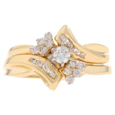 a yellow gold ring with diamonds on it