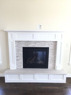 a white fireplace with a black fire place