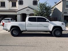 a white truck parked in front of a house