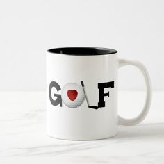 a white and black coffee mug with the word golf in red heart on it's side