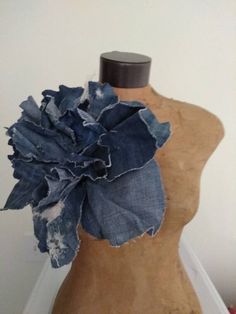 a mannequin with a piece of denim on it's back and a flower in the middle