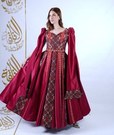 Intricate Tatreez Embroidery:Discover the beauty of traditional Palestinian craftsmanship, adding elegance and cultural depth to your ensemble with exquisite Tatreez embroidery. Elegant Sophistication:Perfectly enhances your wedding attire with timeless beauty and refined elegance, making it a standout choice for your special day. Flowy Ball Gown Silhouette:Offers a flattering fit for all body types, ensuring both comfort and grace, allowing you to move with ease and confidence. Perfect for Henn Flowy Ball Gown, Henna Ceremony, Henna Dress, Bridal Embroidery, Red Ball Gowns, Gown Silhouette, Traditional Henna, Bridal Design, Elegant Embroidery