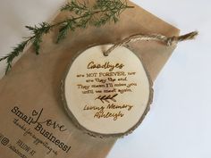 a wooden ornament with a message on it sitting on top of a piece of paper