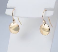 "14K solid gold earrings. 14K solid gold tiny disc earrings. Tiny gold disc earrings. Simple earrings. Dainty earrings. Gift for her. These earrings are simple and can be worn everyday. * 14K solid gold disc is 3/8\", 22 gauge. Please select yellow gold or white gold. * 14K solid gold ear wire The earrings will be shipped in a nice gift box. To see add-on click on the link below. https://www.etsy.com/shop/SashJewelry?section_id=12359884 To see more children's jewelry click on the link below. htt Gold Disc Earrings, Dainty Gold Earrings, Gold Heart Bracelet, Silver Bar Necklace, Solid Gold Necklace, Gold Disc, Solid Gold Earrings, Disc Earrings, Earrings Simple