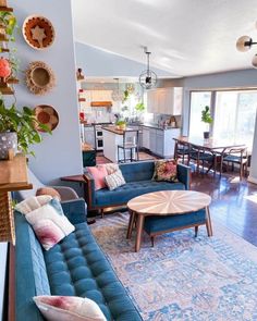 a living room filled with blue couches and lots of pillows on top of them