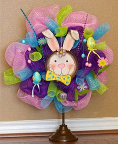 a purple and green wreath with a bunny on it