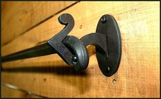 an iron hook on the side of a wooden door