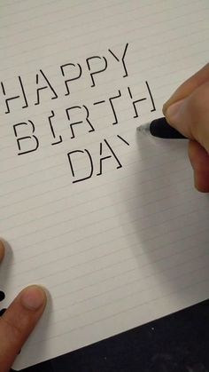 someone is writing happy birthday on a piece of paper